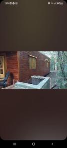a picture of a log cabin with at cabañas y camping jv in Leandro N. Alem