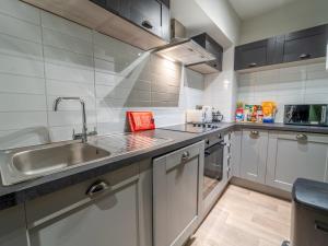 a kitchen with a sink and a counter top at Sophisticated private getaway Pass the Keys in Beeston