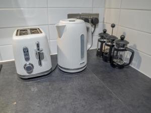 a counter top with a toaster and a coffee maker at Sophisticated private getaway Pass the Keys in Beeston