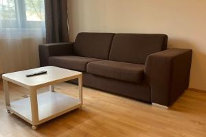 a living room with a couch and a coffee table at Residence Garden Tower - Parking in Prague