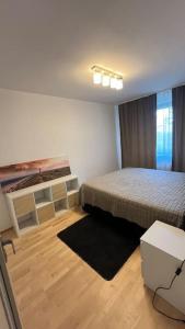 a small bedroom with a bed and a table at Residence Garden Tower - Parking in Prague