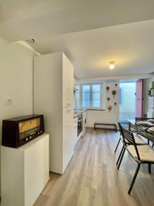 a kitchen with a table and a dining room at * Maison chez J&J - Cité médiévale * in Carcassonne
