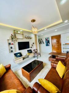 a large living room with a couch and a tv at شقة وسط أكادير in Agadir