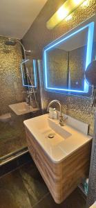 a bathroom with a sink and a mirror at Sea View Studio in Constanţa