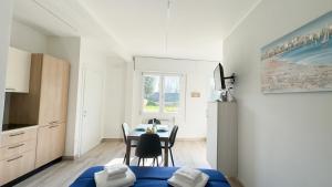 a kitchen and dining room with a table and chairs at Onda Blu House by Ca-Sa Check in Chioggia