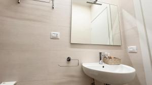 a bathroom with a sink and a mirror at Onda Blu House by Ca-Sa Check in Chioggia +15 photos