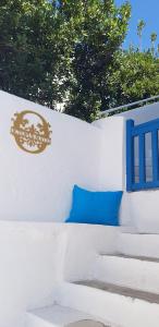 a wall with a blue pillow and a sign on it at Octopus Suites Parikia in Parikia