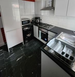 a kitchen with a sink and a dishwasher at House in Newton-le-Willows in Newton-le-Willows