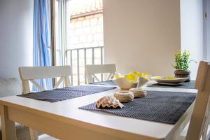 a dining room table with a blue table cloth on it at Lemon&Stone in Korčula