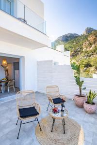 two chairs and a table on a patio at Yploui Suites in Karpathos