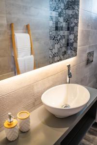 a bathroom with a sink and a mirror at Yploui Suites in Karpathos