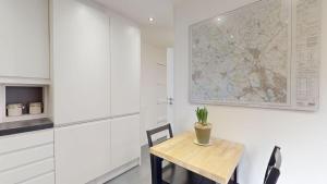 a kitchen with a table and a map on the wall at Pitts Cottage Annexe in Bladon