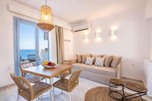 a living room with a couch and a table at Yploui Suites in Karpathos