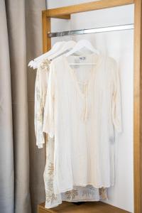 a white shirt on a hanger in a closet at Yploui Suites in Karpathos