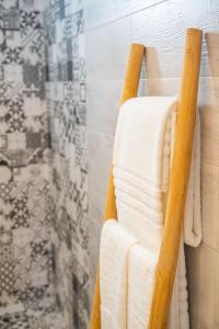a towel hanging on a towel rack in a bathroom at Yploui Suites in Karpathos