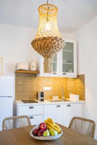 a plate of fruit on a table in a kitchen at Yploui Suites in Karpathos