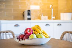 a bowl of fruit on a table in a kitchen at Yploui Suites in Karpathos