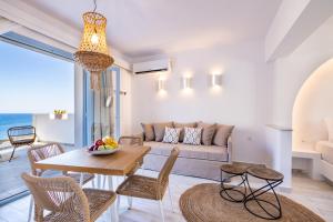 a living room with a couch and a table at Yploui Suites in Karpathos
