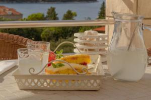 a tray of food and a bottle of milk on a table at Apartment Dino in Lopud Island