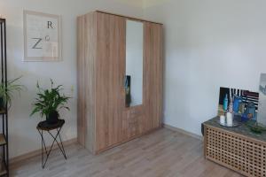 a wooden door with a mirror in a room at Quiet & Family Friendly, Free Parking, Near Park in Rīga