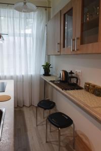 a kitchen with two stools in front of a counter at Quiet & Family Friendly, Free Parking, Near Park in Rīga