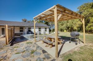 a wooden pergola with a picnic table and a grill at College Station Vacation Rental 4 Mi to Texas AandM in College Station