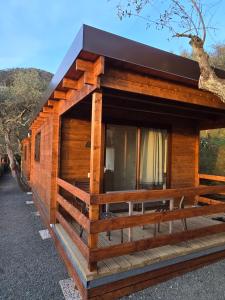 a log cabin with a black roof at Campeggio Gianna Golfo dei Poeti in Lerici