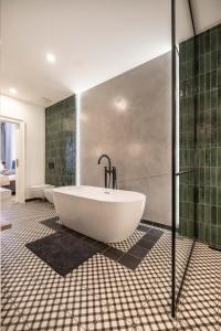 a large bathroom with two tubs and a shower at Apartmány Marienhof in Znojmo