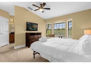 a bedroom with a bed and a ceiling fan at Luxury Townhome - 5 min to Disney World in Orlando