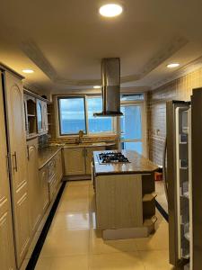 a large kitchen with a stove top island in it at Chantel Sea View in Dar es Salaam