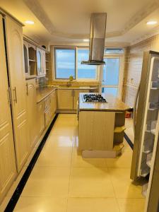 a kitchen with a stove top island in a room at Chantel Sea View in Dar es Salaam