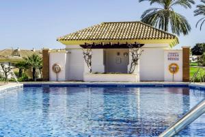 a swimming pool in front of a villa at 111 - Penthouse Apartment, La Cala in Mijas