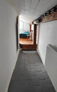 a hallway with a room with a bed and a chair at Seeyouin Karmelicka18 Apartment in Krakow