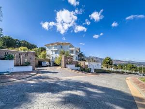 a villa with a driveway in front of a house at 111 - Penthouse Apartment, La Cala in Mijas