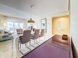 a dining room with a white table and chairs at 111 - Penthouse Apartment, La Cala in Mijas