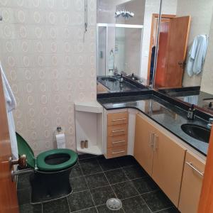 a bathroom with a green toilet and a sink at Hostel On Top1 CGH SP Congonhas São Paulo in Sao Paulo