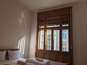 a bedroom with a window and a bed in front of it at Ultra-central apartment in the Loffler Palace in Timişoara