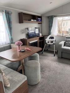 a living room with a table and a couch at Seton sands caravan rental in Port Seton