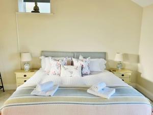 a bedroom with a bed with two towels on it at The Stable in The Dales in Silsden