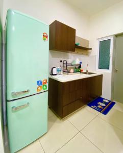 a kitchen with a refrigerator and a sink at Mesahill 2 Bedroom (Deluxe Queen) by DKAY in Nilai in Nilai