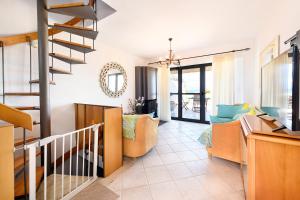 a living room with a staircase and a living room at VILLAGE CLUB 27 in Nea Fokea