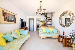 a living room with two couches and a mirror at VILLAGE CLUB 27 in Nea Fokea
