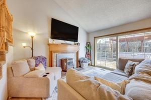 a living room with a couch and a fireplace at Pet-Friendly Colorado Springs Home with Mtn Views! in Colorado Springs