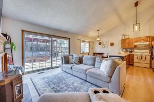 a living room with a couch and a kitchen at Pet-Friendly Colorado Springs Home with Mtn Views! in Colorado Springs