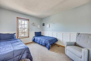 a bedroom with a bed and a couch and a window at Pet-Friendly Colorado Springs Home with Mtn Views! in Colorado Springs