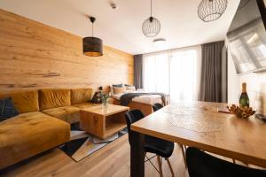 a living room with a couch and a table at Královské apartmány - Špindlerův Mlýn in Špindlerův Mlýn