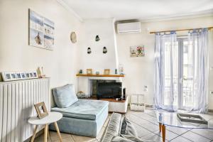 a living room with a couch and a fireplace at Evita's ikia seaside luxury house in Mesongi