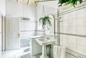 a white bathroom with a sink and a mirror at Evita's ikia seaside luxury house in Mesongi +70 photos