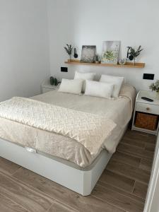 a white bedroom with a bed with white walls at La Repera in Palamós