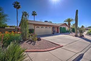 a house with palm trees and a driveway at Mesa Outdoor Oasis with Private Pool and Patio! in Mesa
